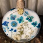 Large glass jar of epsom salts with pressed flower design