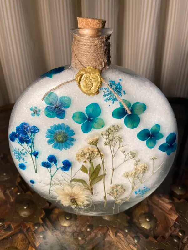Large glass jar of epsom salts with pressed flower design